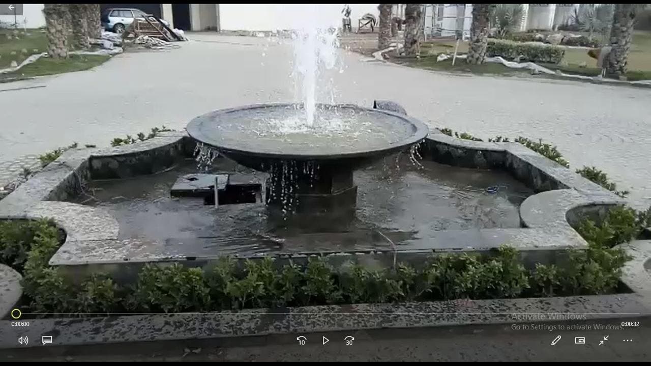 Circular fountain constructed within a formal courtyard